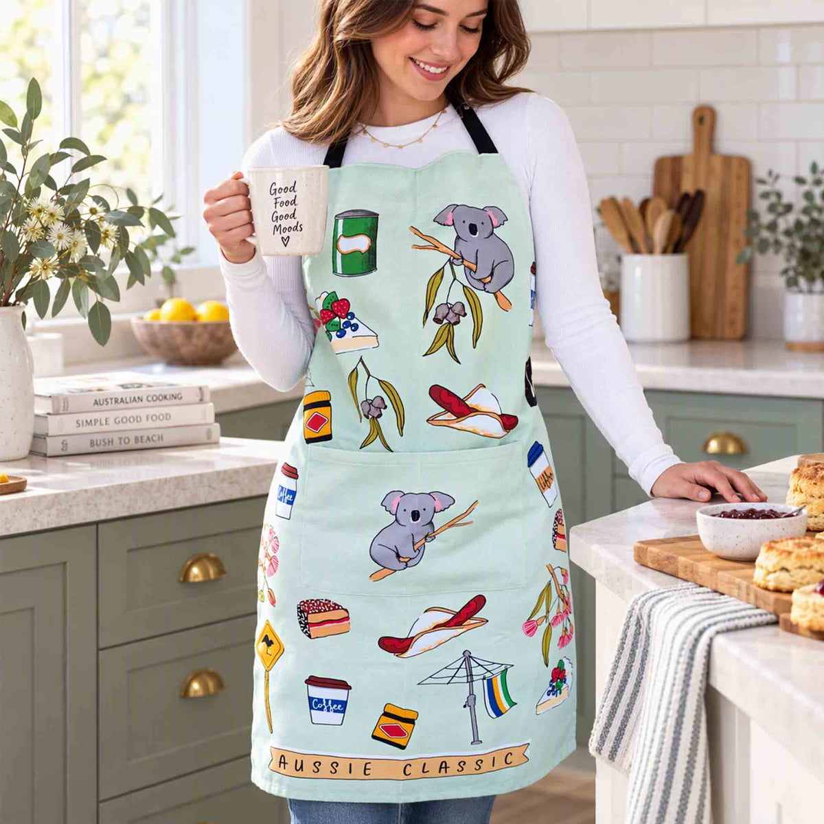 Person wearing Aussie Classics cotton heavy drill apron in a bright kitchen while enjoying a morning coffee