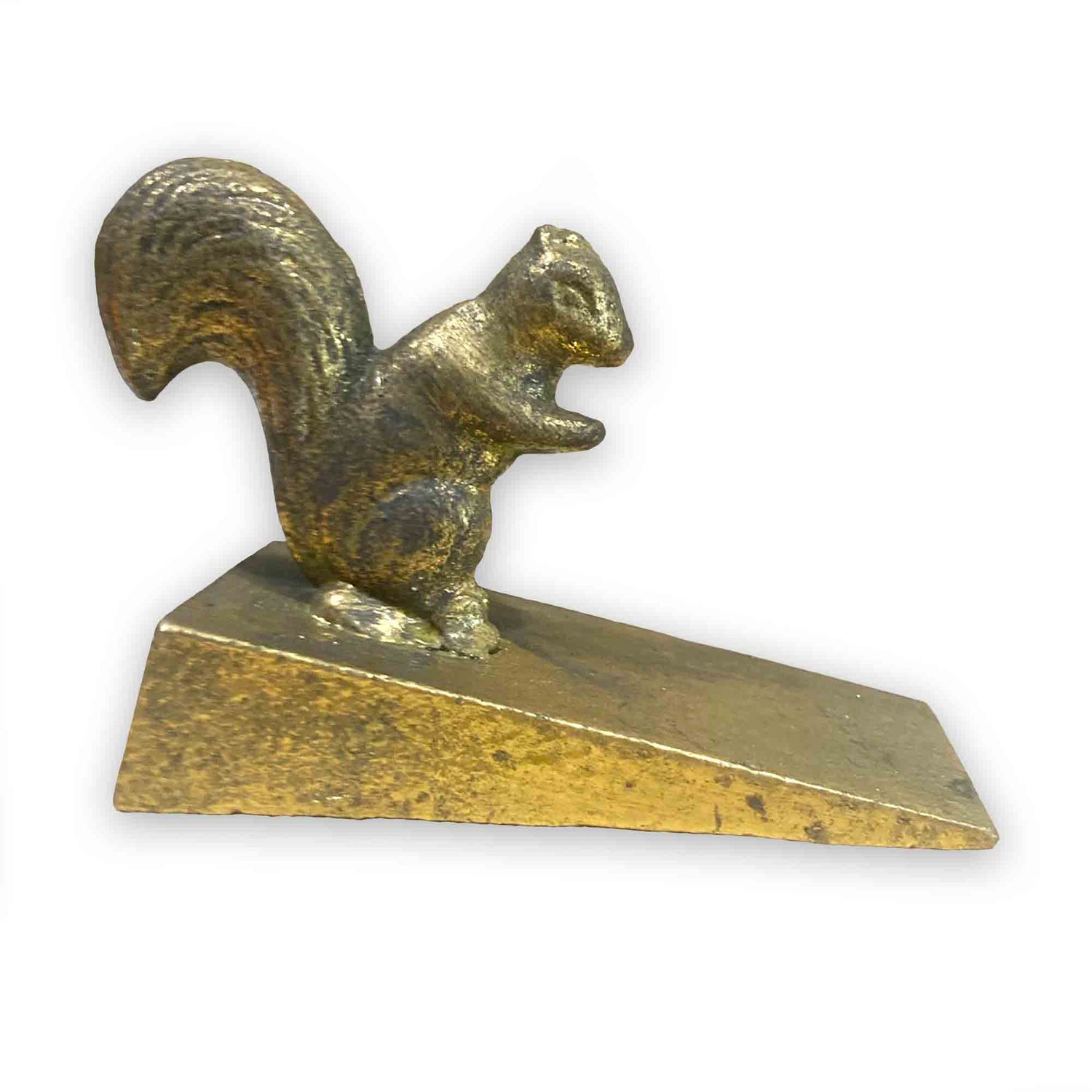 Gold coloured metal squirrel door stop wedge on a white background