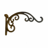 Decorative metal bracket with intricate design on a white background