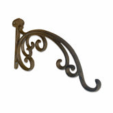Decorative metal bracket with intricate design on a white background
