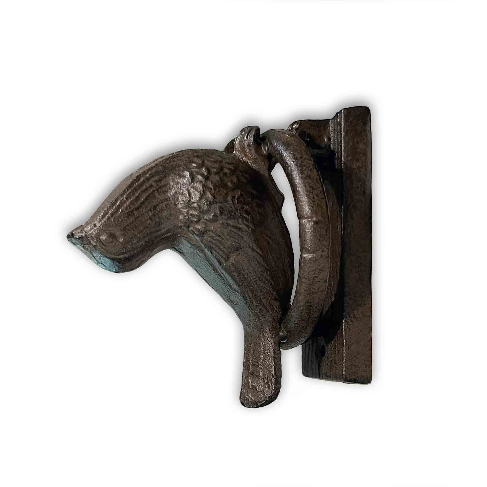 Decorative metal bird-shaped door knocker on a white background