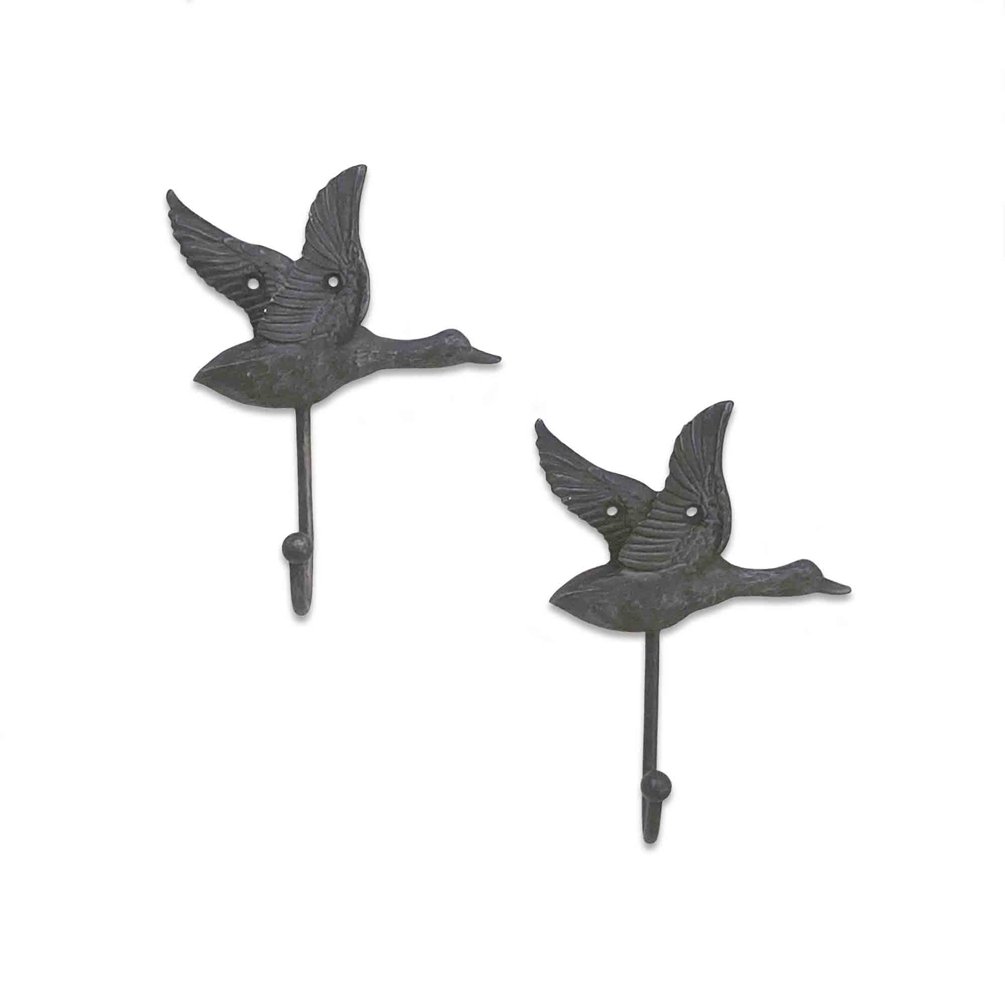 Two metal wall hooks shaped like flying ducks on a white background