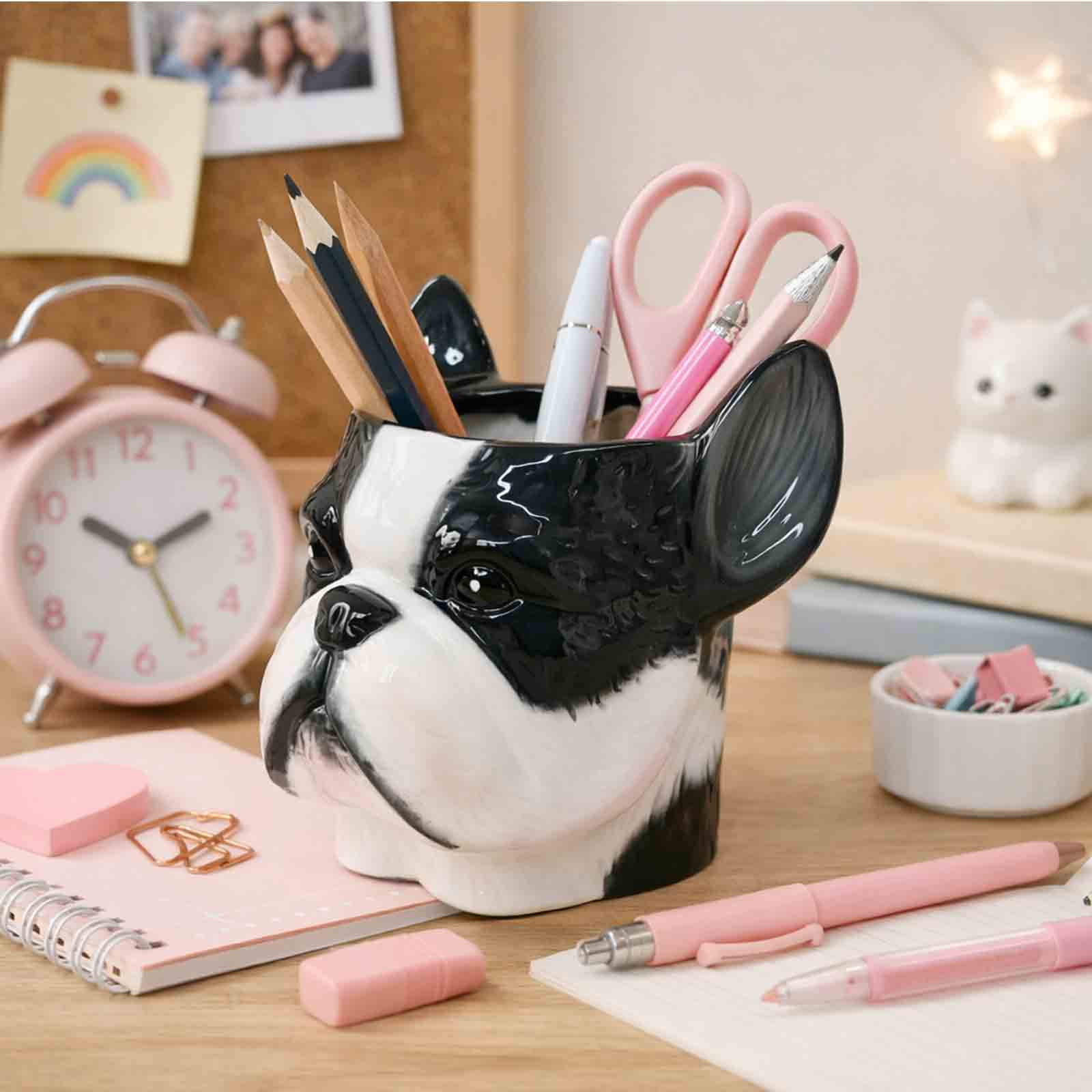 Dog-shaped pencil holder on a desk with stationery items
