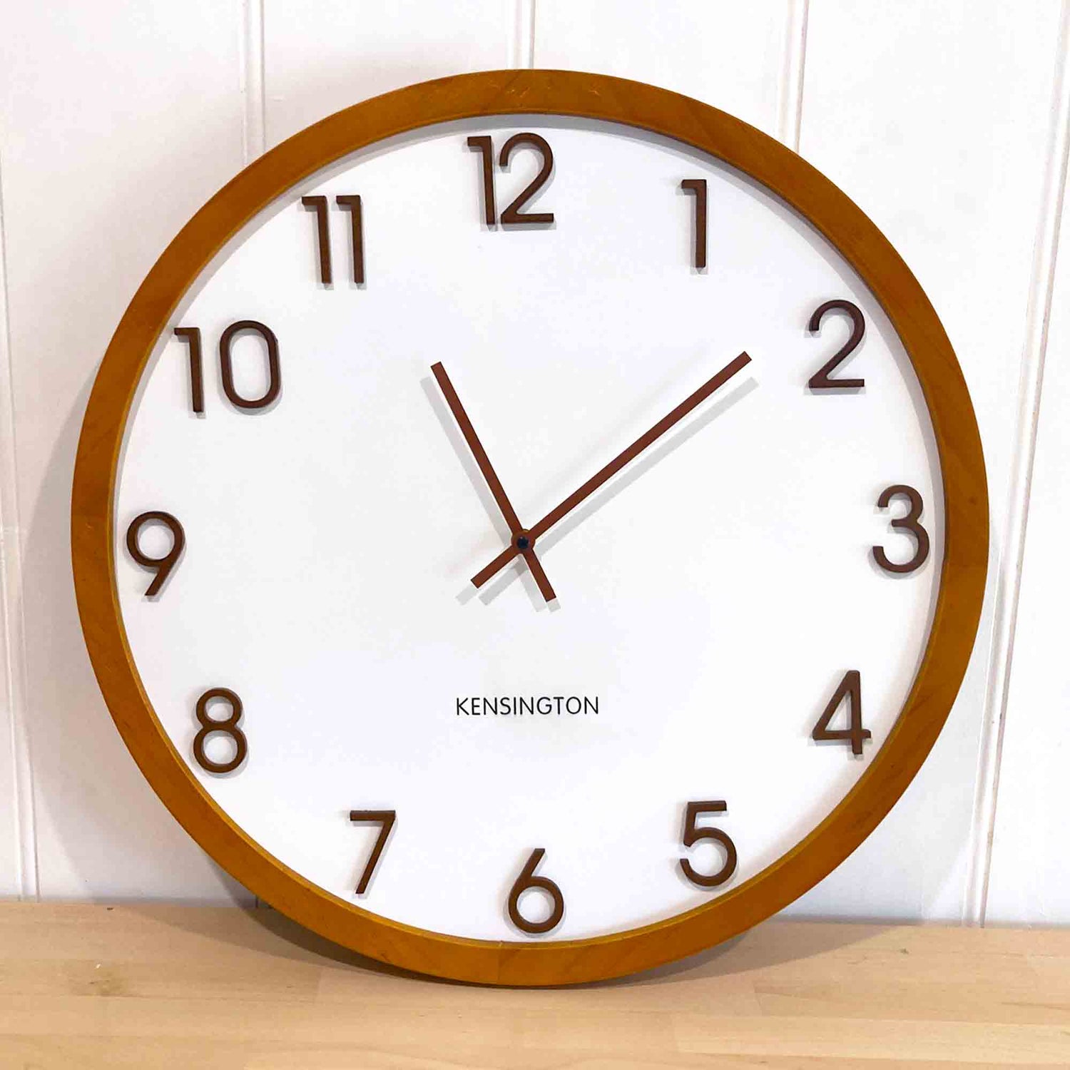 Kensington Wood Wall Clock - Brown timber framed clock with a white face and raised brown numbers.
