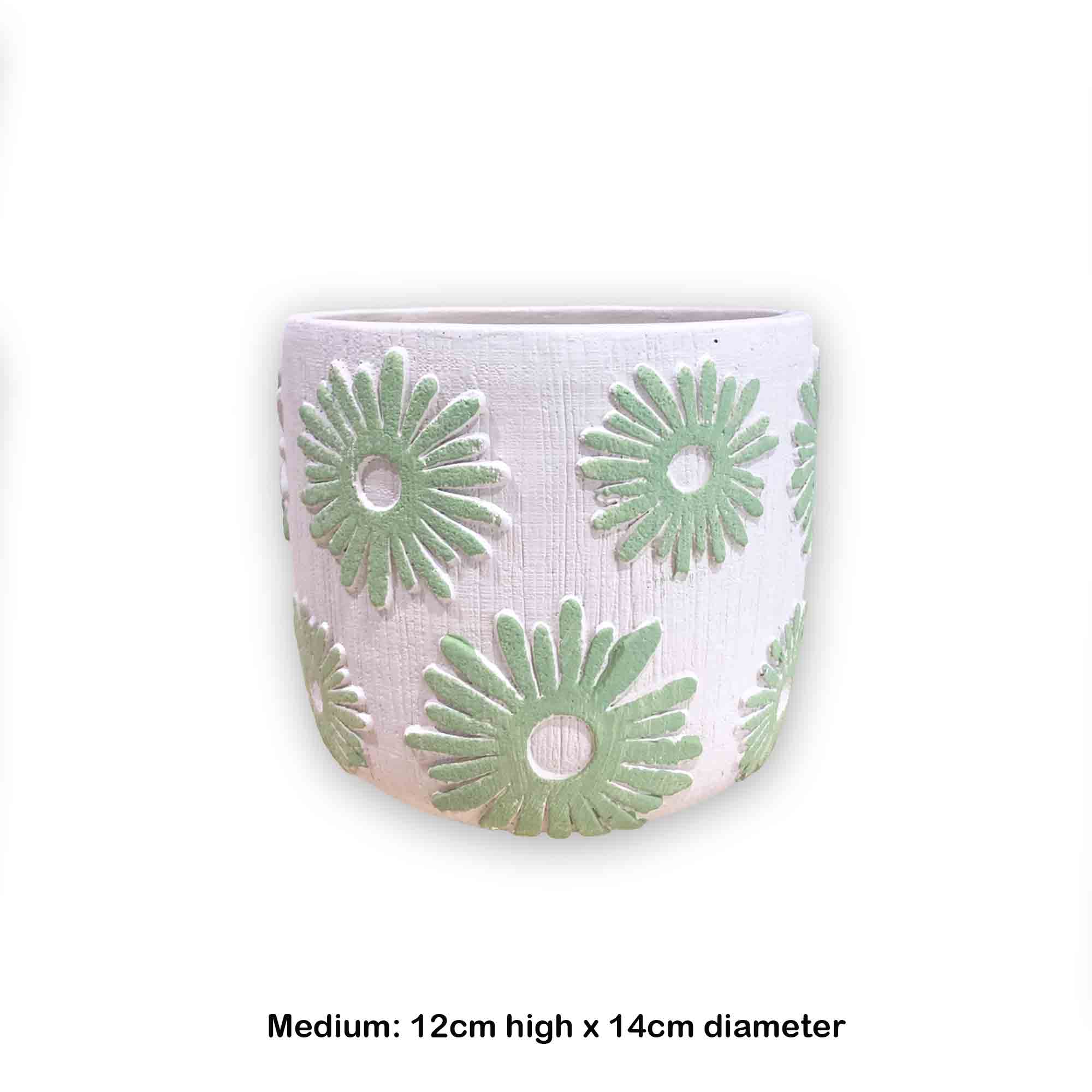 Concrete pot with green floral daisy pattern on a white background