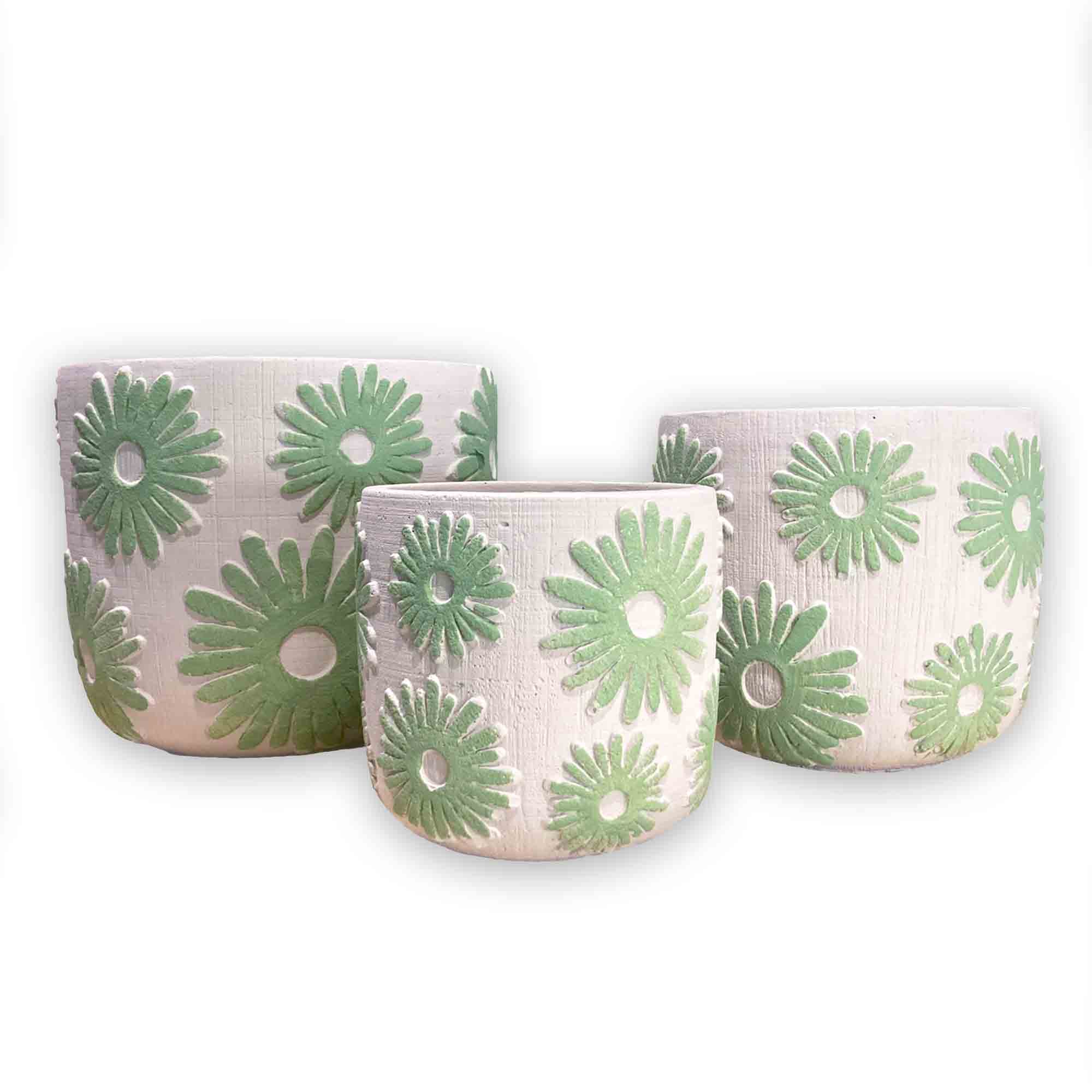 Set of three concrete planters with green floral daisy patterns on a white background
