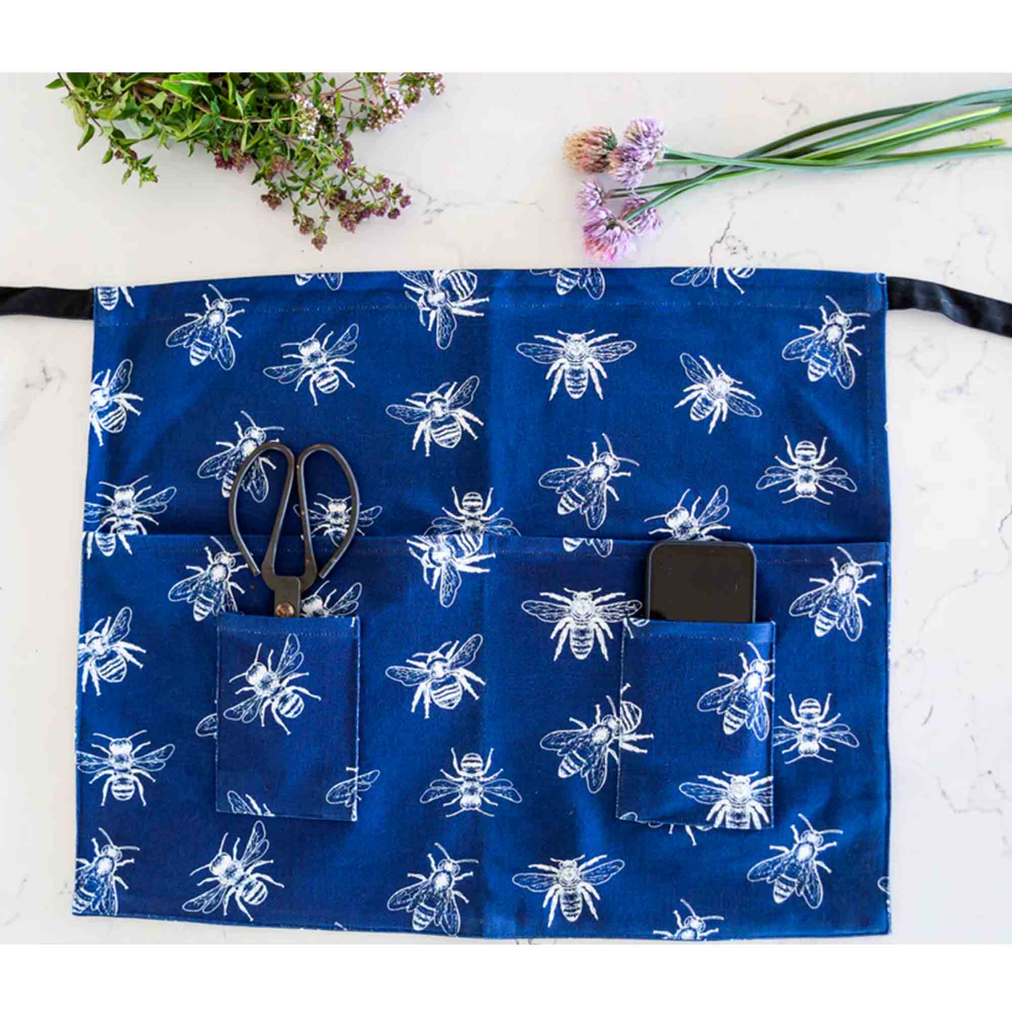 Blue apron with bee pattern on a white background