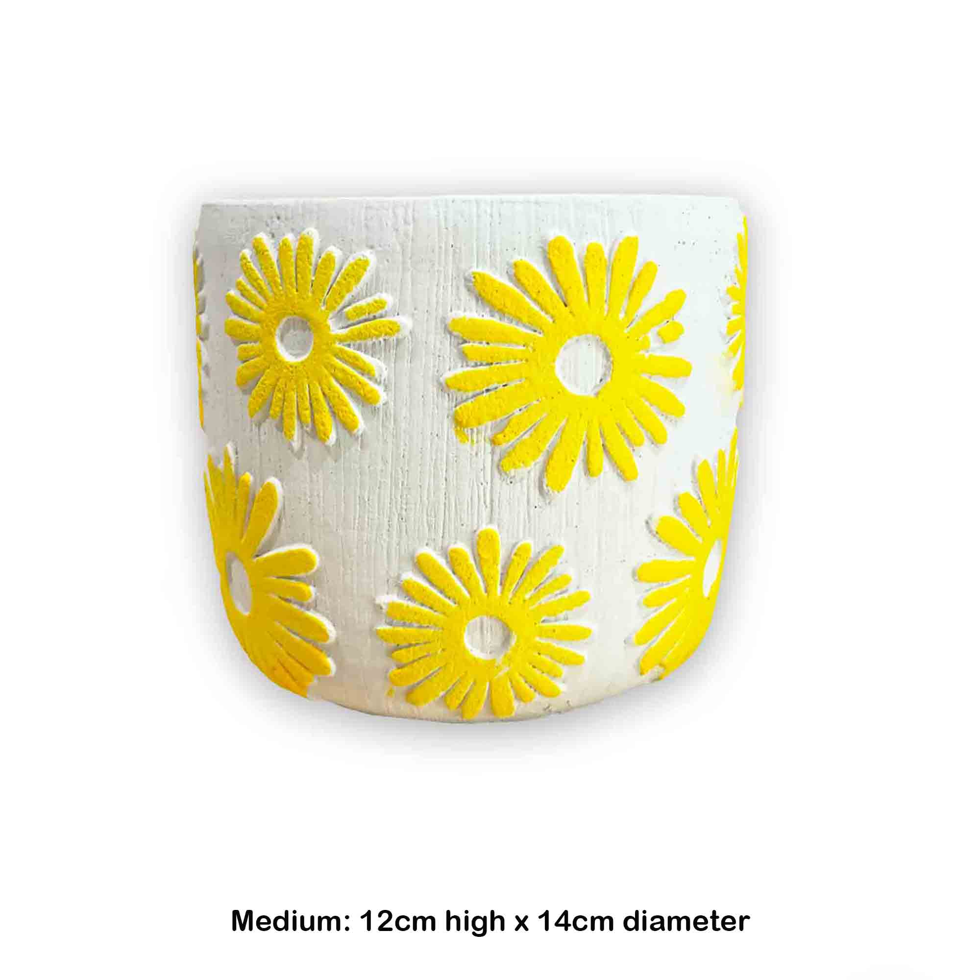 Ceramic planter with yellow floral patterns on a white background