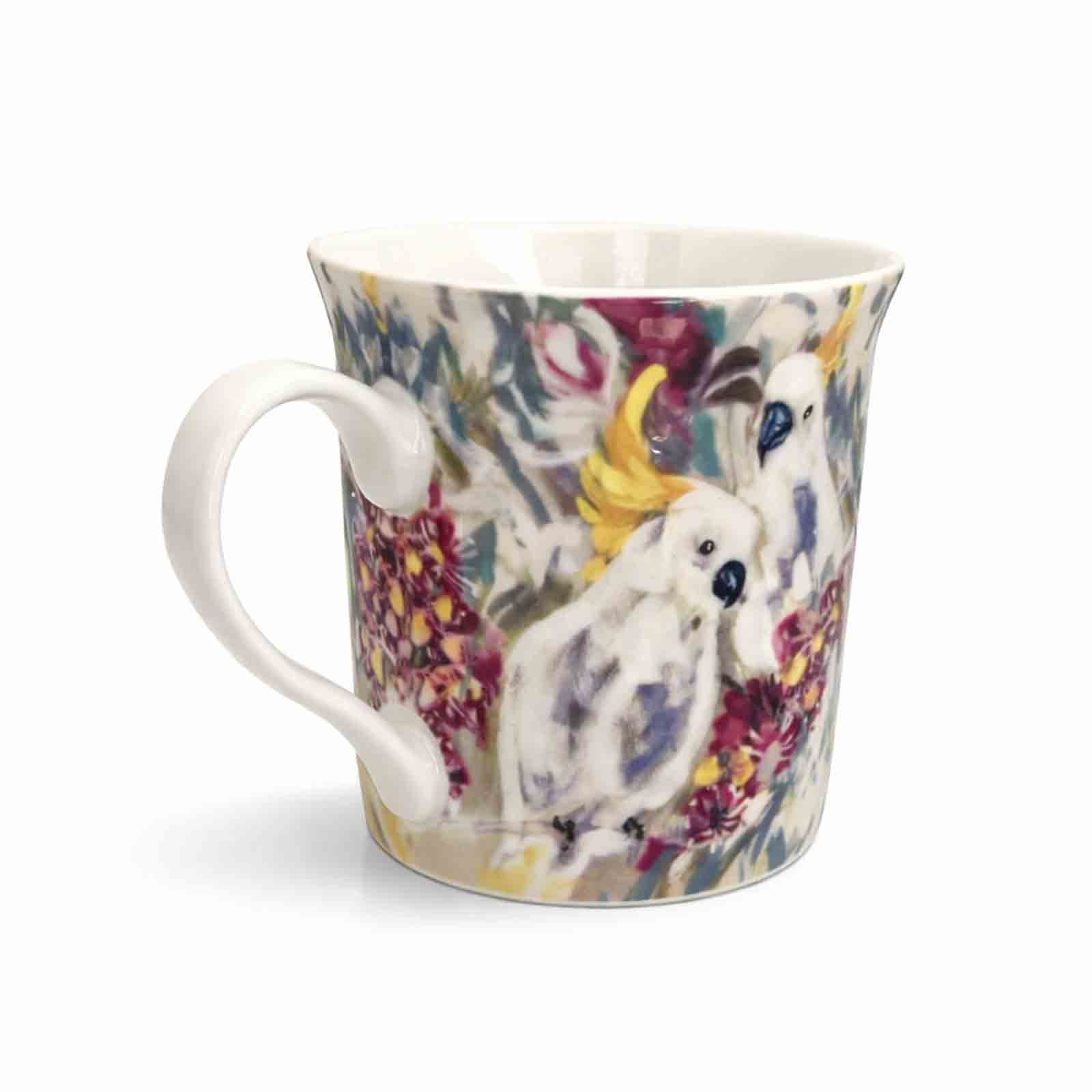 A 300ml new bone china mug featuring Amanda Brooks’ Cockatoo &amp; Gum artwork, showing white cockatoos among colourful native gum blossoms with a glossy finish