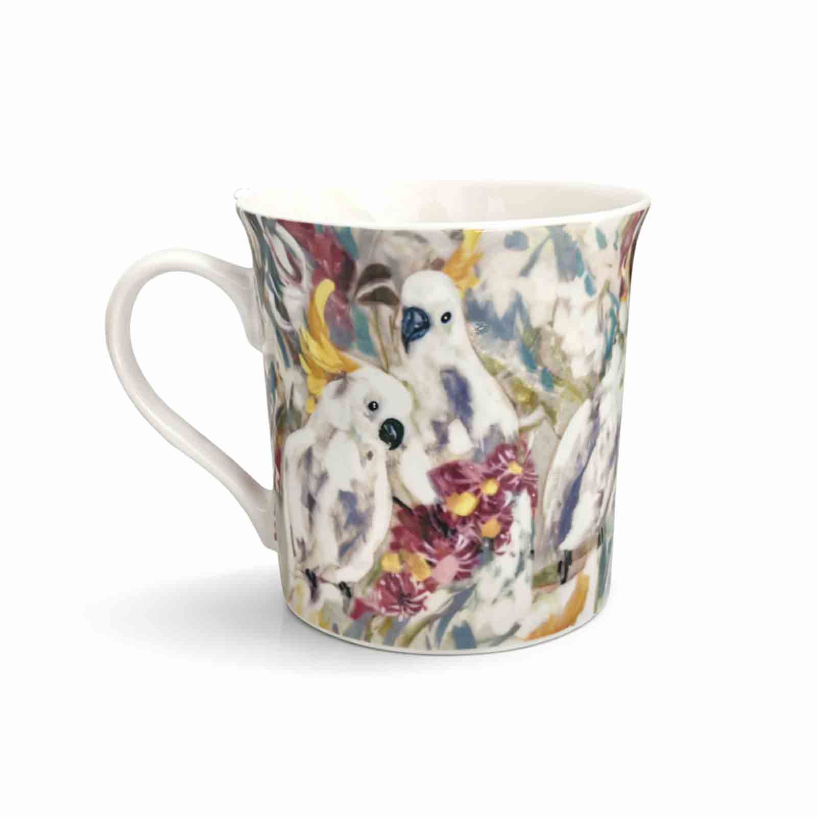A 300ml new bone china mug featuring Amanda Brooks’ Cockatoo &amp; Gum artwork, showing white cockatoos among colourful native gum blossoms with a glossy finish