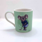 Green mug with a koala design holding a golf club on a white background