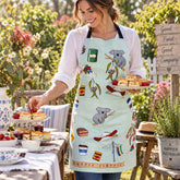 Person wearing Aussie Classics cotton heavy drill apron serving fresh scones and jam at a garden morning tea setting