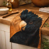 Kitchen tea towel with a Black Cockatoo design on a wooden surface