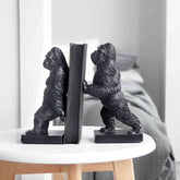 Black gorilla-shaped bookends on a white surface with a neutral background