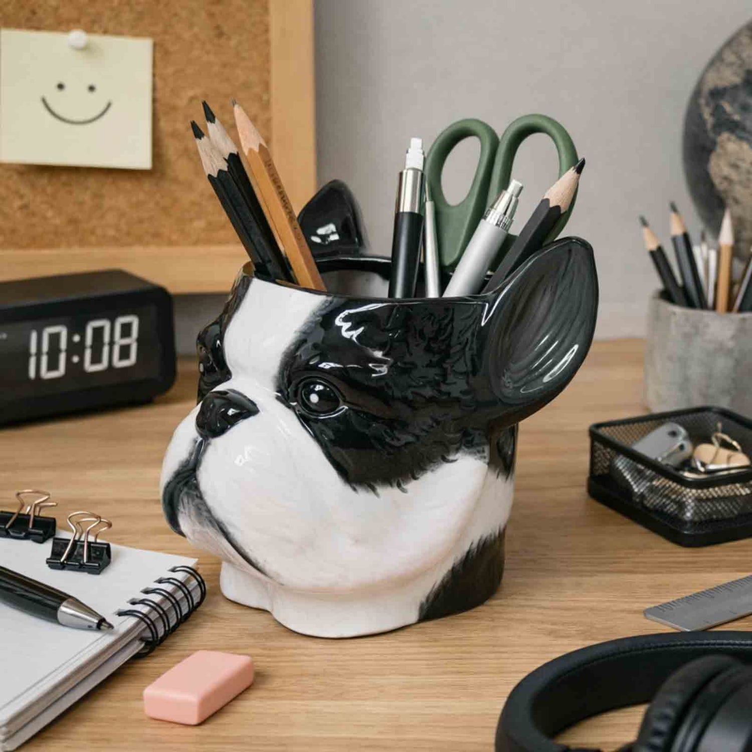 Dog-shaped pen holder on a desk with office supplies