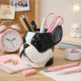 Dog-shaped pencil holder on a desk with stationery items