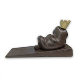 Decorative door stopper shaped like a frog with a crown on a white background