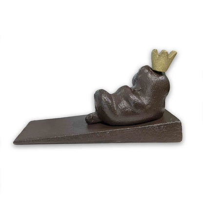 Decorative door stopper shaped like a frog with a crown on a white background