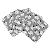 Set of four coasters with a sheep pattern on grey background