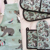 Set of kitchen items with koala pattern on a light green background
