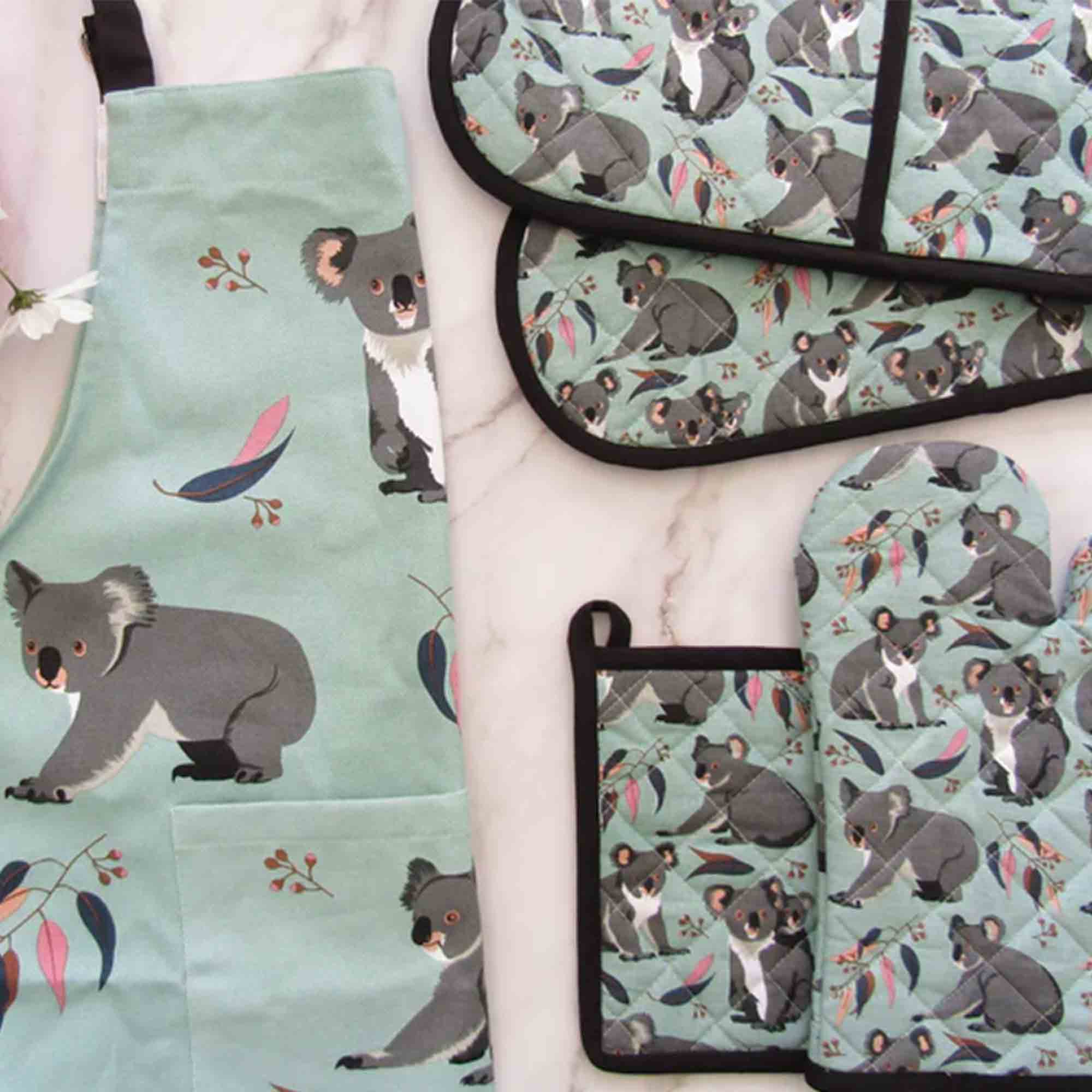 Set of kitchen items with koala pattern on a light green background