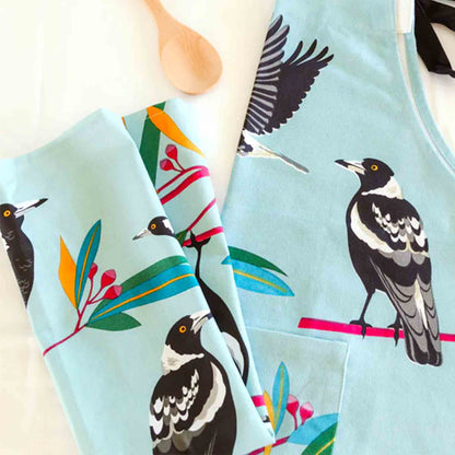 Light blue fabric with magpie and floral pattern on a white background