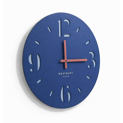 Blue wall clock with Westbury Studio branding on a white background
