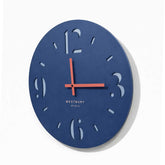 Side angle of modern blue wall clock showing layered MDF construction