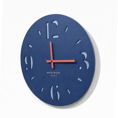 Side angle of modern blue wall clock showing layered MDF construction