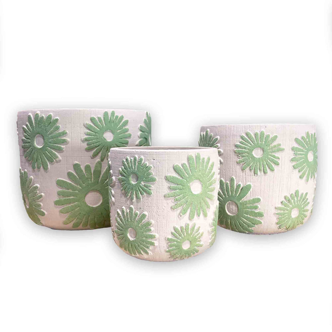 Set of three concrete planters with green floral daisy patterns on a white background