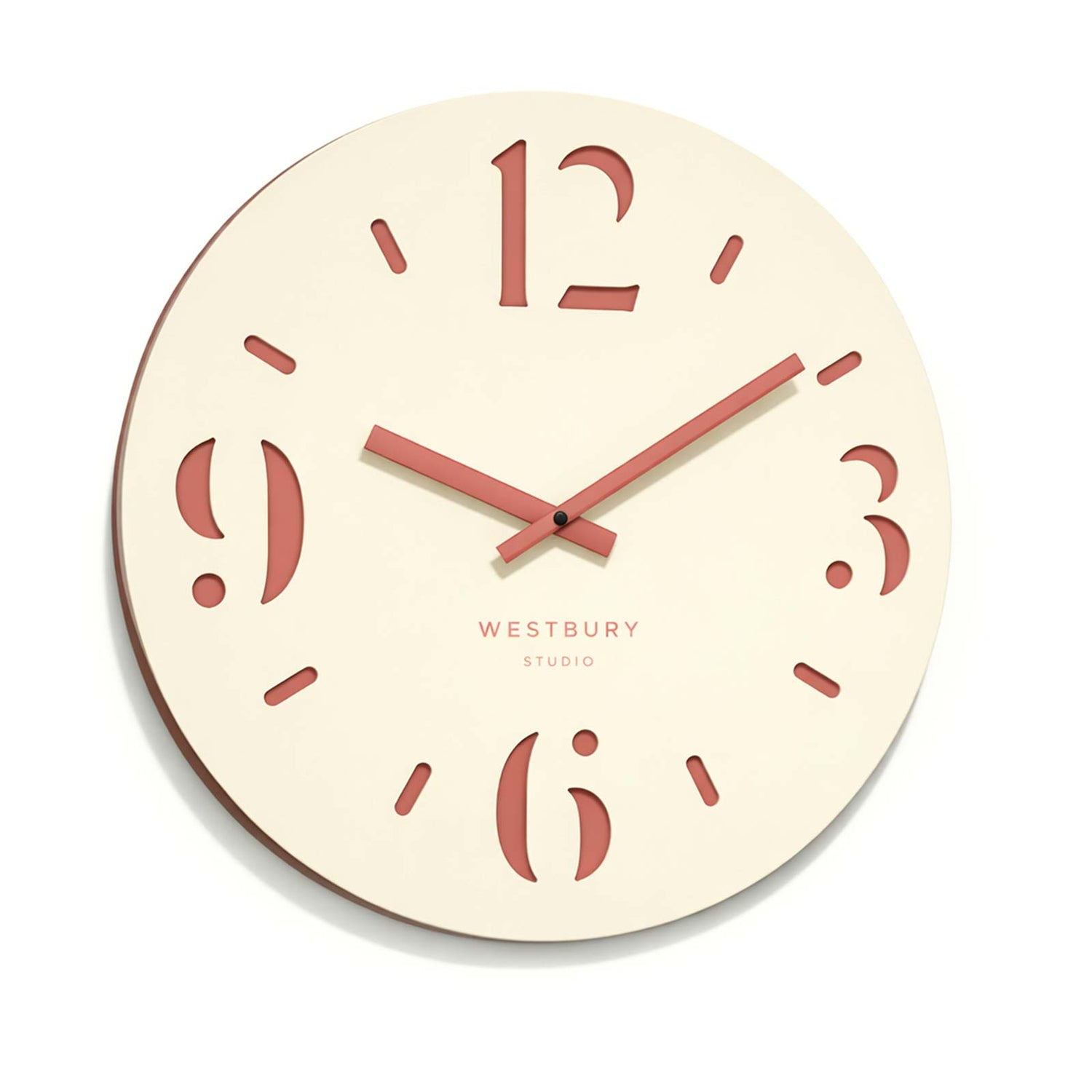 Cream coloured clock with cut out numerals on a dusty pink back.