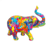 Colorful elephant figurine with splatter paint design on a white background