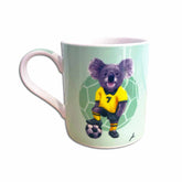 Mug with a koala in a soccer uniform on a light green background
