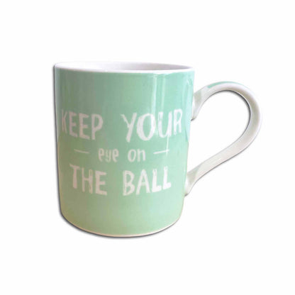 Mint green mug with white text on a white background