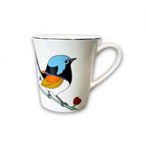 White mug with a colorful bird design on a white background