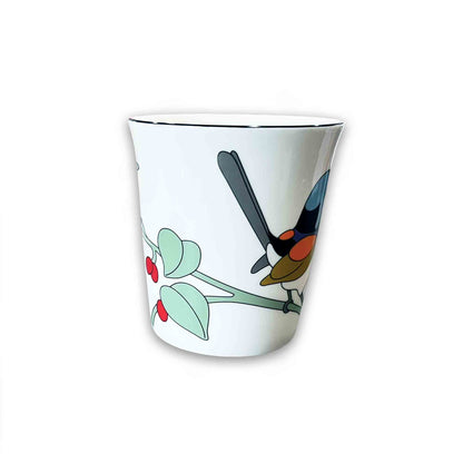 White mug with a colorful bird design on a white background