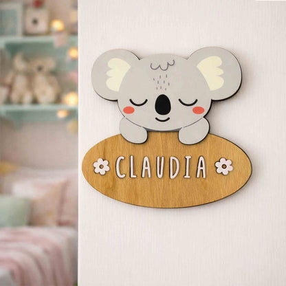A personalized wooden koala nameplate sign with a gray cartoon koala and the name &