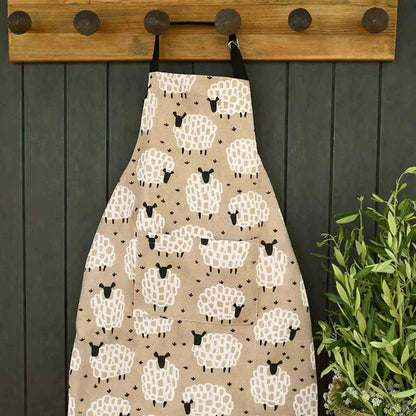 Greyish Beige sheep‑pattern apron hanging in mudroom - Hello Homewares
