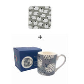 Ceramic mug with sheep pattern, packaging, and matching coaster on a white background